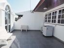 Outdoor balcony with seating and air conditioning unit