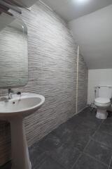 Modern bathroom with sink, mirror, and toilet