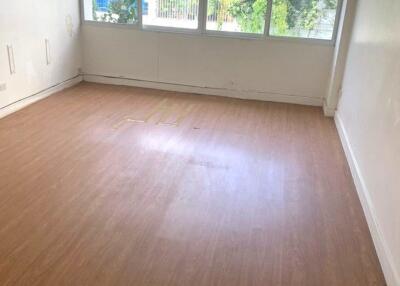 Empty room with hardwood floor and large windows