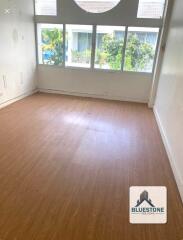 Empty room with hardwood floor and large windows