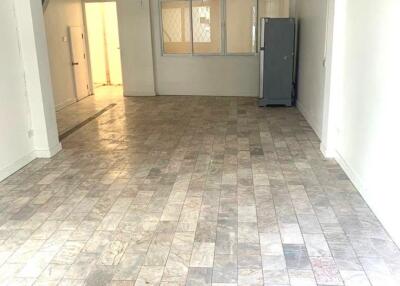 Spacious empty main living area with tiled floor