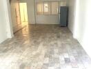 Spacious empty main living area with tiled floor