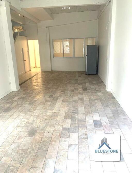 Spacious empty main living area with tiled floor