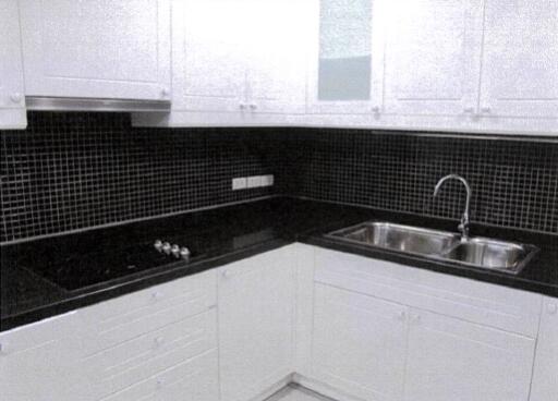 Modern kitchen with black countertops and a tiled backsplash