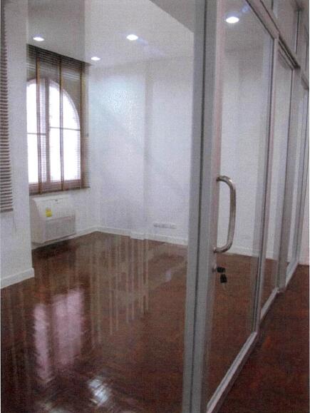 Office space with glass partition and wooden floor