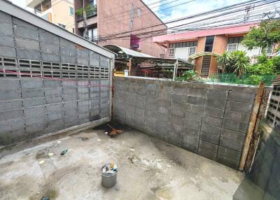 Enclosed backyard space with concrete walls