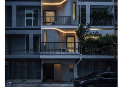 Modern multi-story residential building at dusk