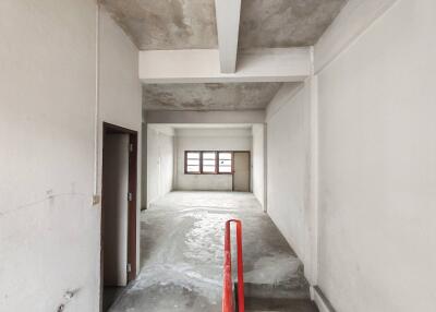 Spacious unfinished room with windows and structural beams