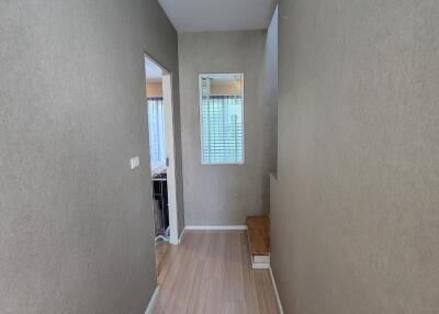 Hallway with wooden flooring and beige walls
