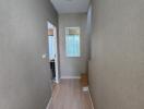 Hallway with wooden flooring and beige walls