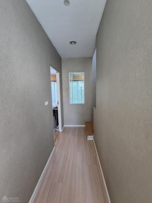 Hallway with wooden flooring and beige walls