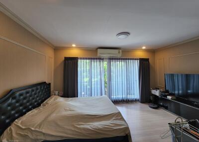 Spacious Bedroom with Bed and Television
