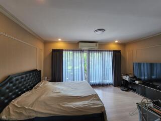 Spacious Bedroom with Bed and Television