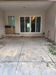 Outdoor patio area with large sliding glass doors