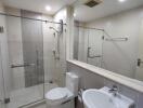 Modern Bathroom with glass shower enclosure and white fixtures