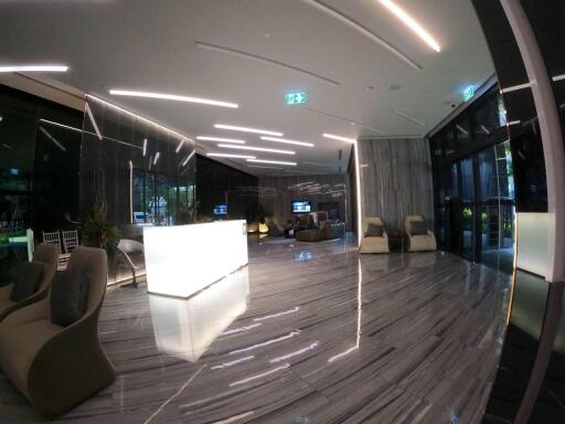 Modern lobby lounge with reflective flooring and contemporary lighting