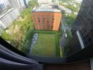 View from apartment overlooking greenery and other buildings