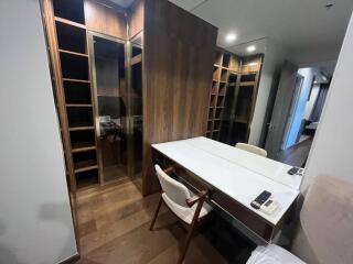 Modern bedroom with a study desk and built-in wooden wardrobe