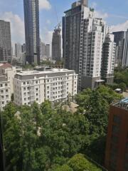 View of high-rise buildings and greenery from a window