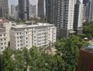 View of high-rise buildings and greenery from a window