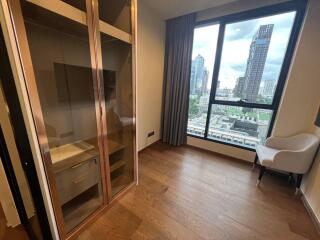 Bedroom with city view and glass-door wardrobe