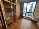 Bedroom with city view and glass-door wardrobe