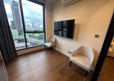 Modern living room with large window, air conditioning, and wall-mounted TV