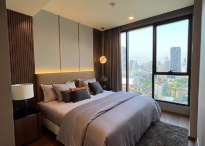 Modern bedroom with large windows and city view