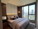 Modern bedroom with large windows and city view