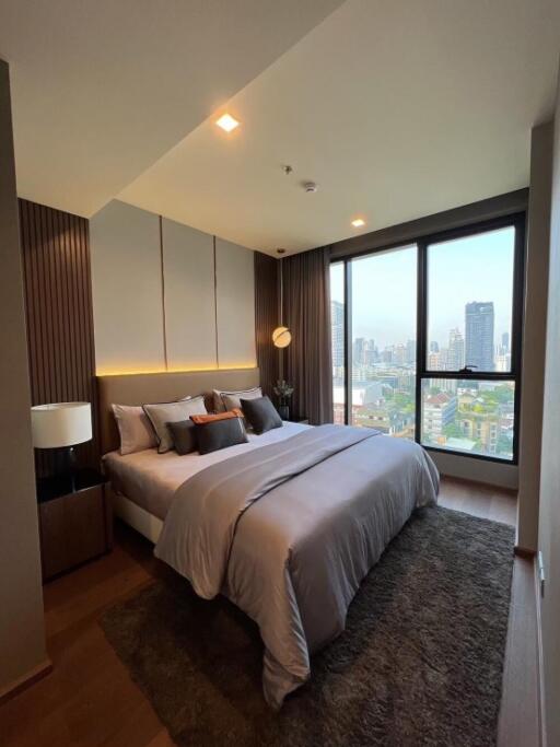 Modern bedroom with large windows and city view