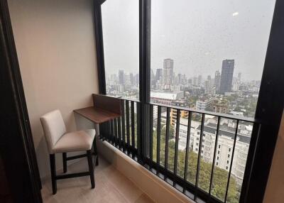 Small balcony with a view of city buildings