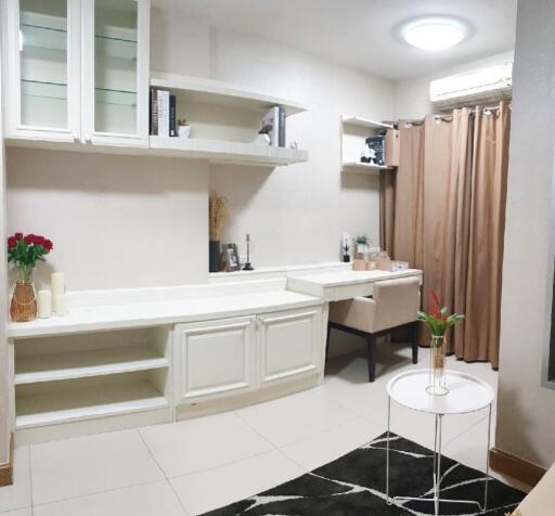 Spacious bedroom with a built-in study desk and shelves