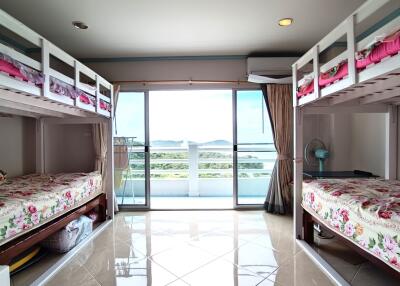 Spacious bedroom with bunk beds and balcony view