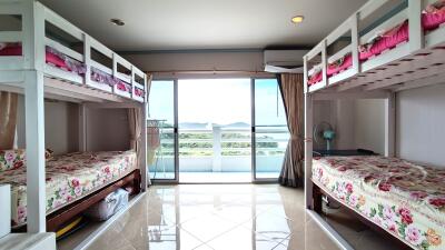 Spacious bedroom with bunk beds and balcony view