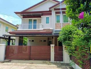 Front view of a two-story house with a gated entrance