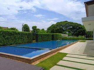 Outdoor swimming pool with well-maintained garden