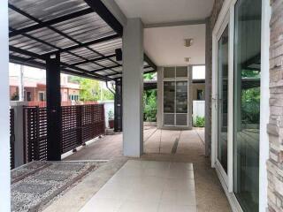 Covered outdoor area with pathway and large windows