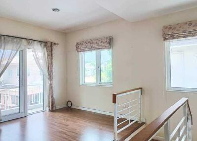 Bright living area with large windows and balcony