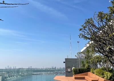 Rooftop pool with city view and seating area