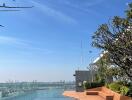 Rooftop pool with city view and seating area