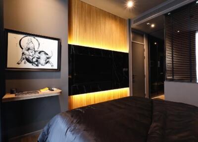 Modern bedroom with ambient lighting and a wall-mounted TV