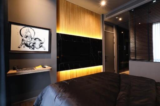 Modern bedroom with ambient lighting and a wall-mounted TV