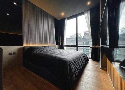 Modern bedroom with large windows and black decor