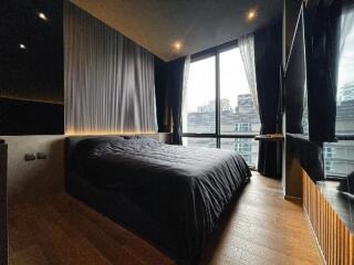 Modern bedroom with large windows and black decor