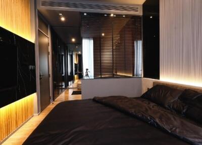 Modern bedroom with dark tones and ambient lighting