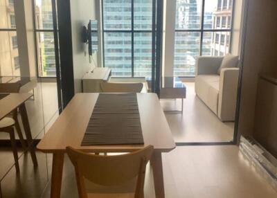 Modern living area with a dining table and large window