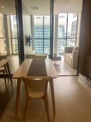 Modern living area with a dining table and large window