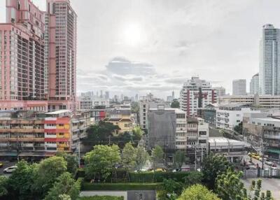 Cityscape view of various buildings and greenery in an urban area