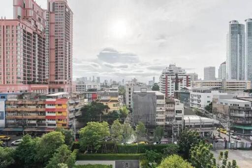 Cityscape view of various buildings and greenery in an urban area