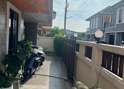 Front porch with plants and motorcycles